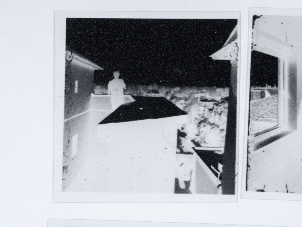 Detailed views of the analog black-and-white negatives created from AI-generated images.